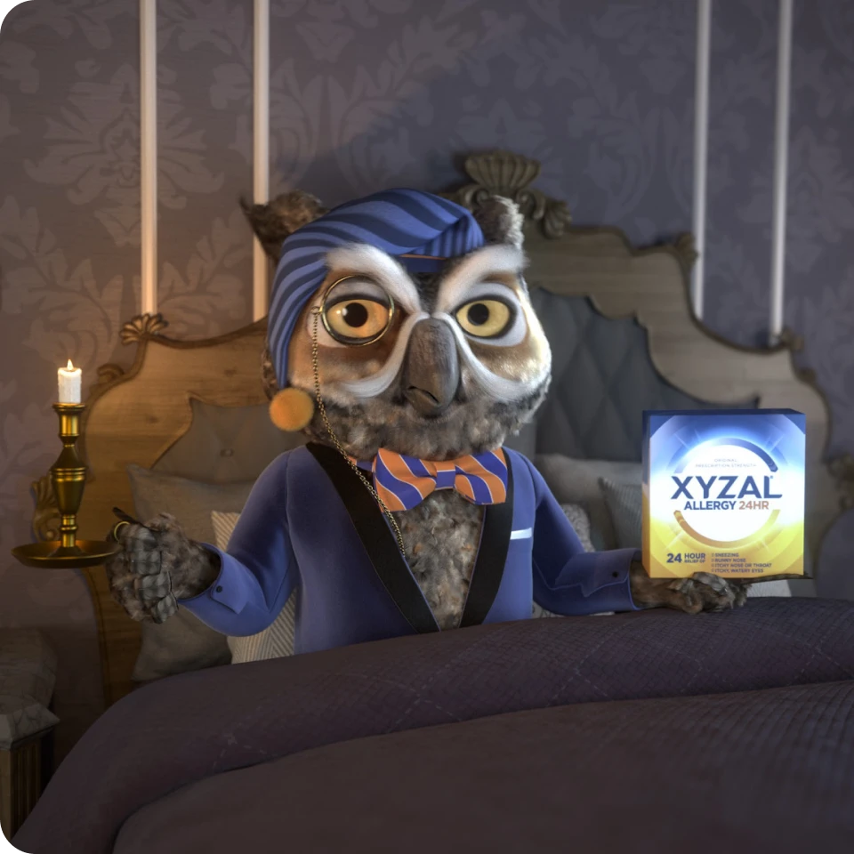 Xyzal's mascot, Nigel the owl, wearing a suit and a stylish bow tie, complete with a night cap, sitting on his bed with a Xyzal Allergy 24HR next to him.
